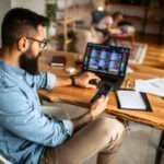 a man is looking at the stock quotes