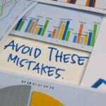 Avoid These Mistakes write on a book isolated on Office Desk. Stock market concept