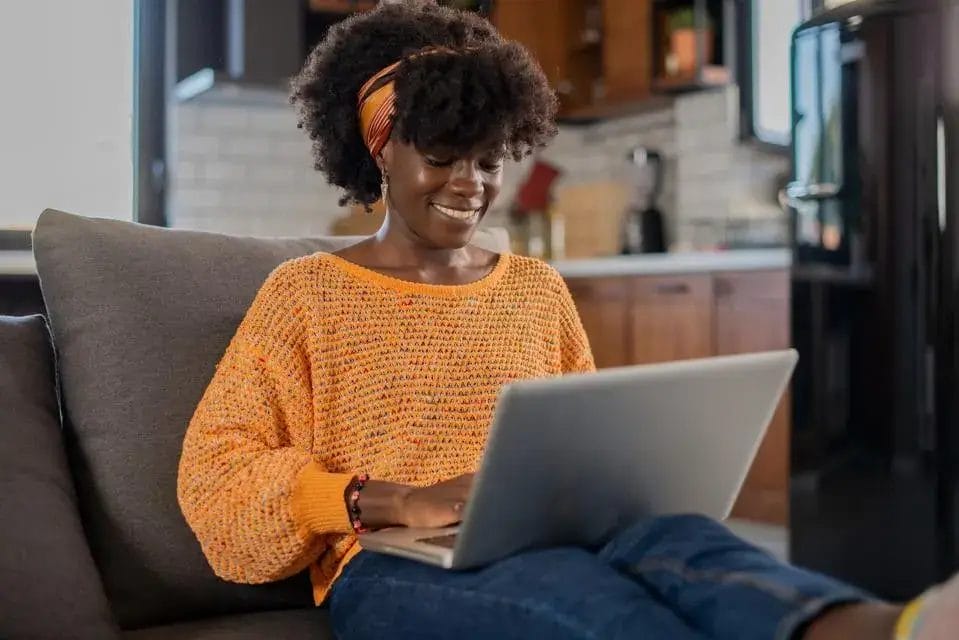 woman happy on her laptop